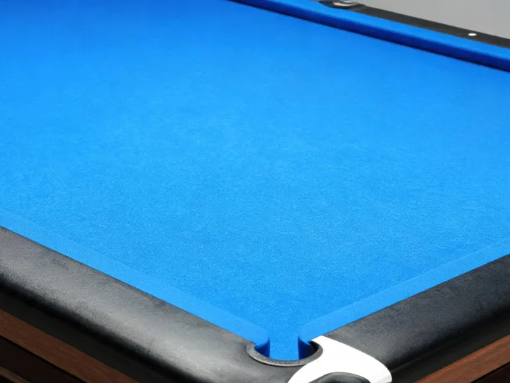 Deep tournament blue worsted billiard cloth fitted to a professional pool table